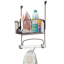 Load image into Gallery viewer, mDesign Metal Over Door Ironing Board Holder with Large Storage Basket - Holds Iron, Board, Spray Bottles, Starch, Fabric Refresher - for Laundry, Utility Room, Garage - Bronze