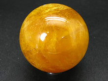 Load image into Gallery viewer, Incredible Agni Golden Yellow Danburite Cats Eye Sphere Ball from Tanzania - 1.9" - 156 Grams

