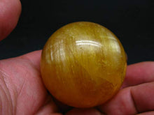 Load image into Gallery viewer, Incredible Agni Golden Yellow Danburite Cats Eye Sphere Ball from Tanzania - 1.9" - 156 Grams
