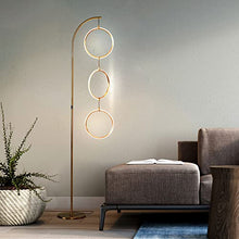 Load image into Gallery viewer, Brightech Nova Modern Floor Lamp - Contemporary Arc Tall Lamp with 3-Circle Ring-Style Pendant - Over The Couch Standing Lamp on Arching Pole - Eclectic Tall Lamp Matches Living Room Décor - Gold
