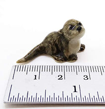 Load image into Gallery viewer, WitnyStore Sea Otter Figurines - Collectible Animal Art - Miniature Hand Made and Painted Porcelain Table Decor Perfect for Gifts and Souvenirs - 1 1/4" L x 1/2" H x 1/2" W
